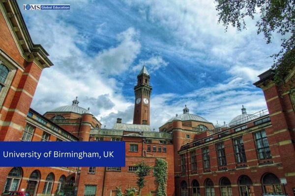 A photograph of the historic red-brick buildings at the University of Birmingham, UK,A blue banner in the lower-left corner identifies the location as 